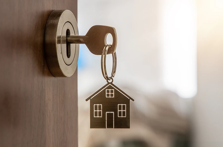 Ein Schlüssel steckt im Schlüsselloch einer Wohnungstür.